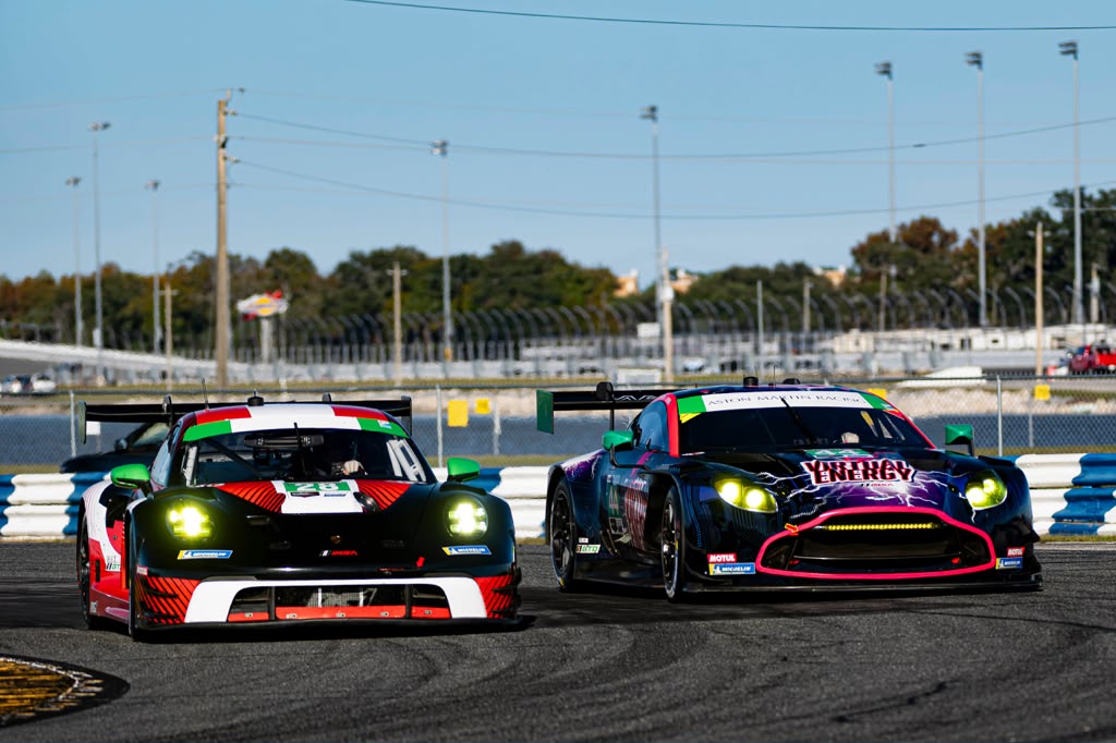 Two GT race cars battling side by side